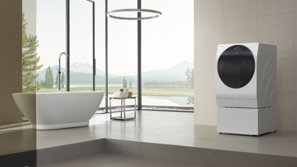 The LG Signature TWINWasg washer dryer stands in an open plan bathroom, overlooking verdant fields. Probably not a typical user case, but it looks stylish enough.